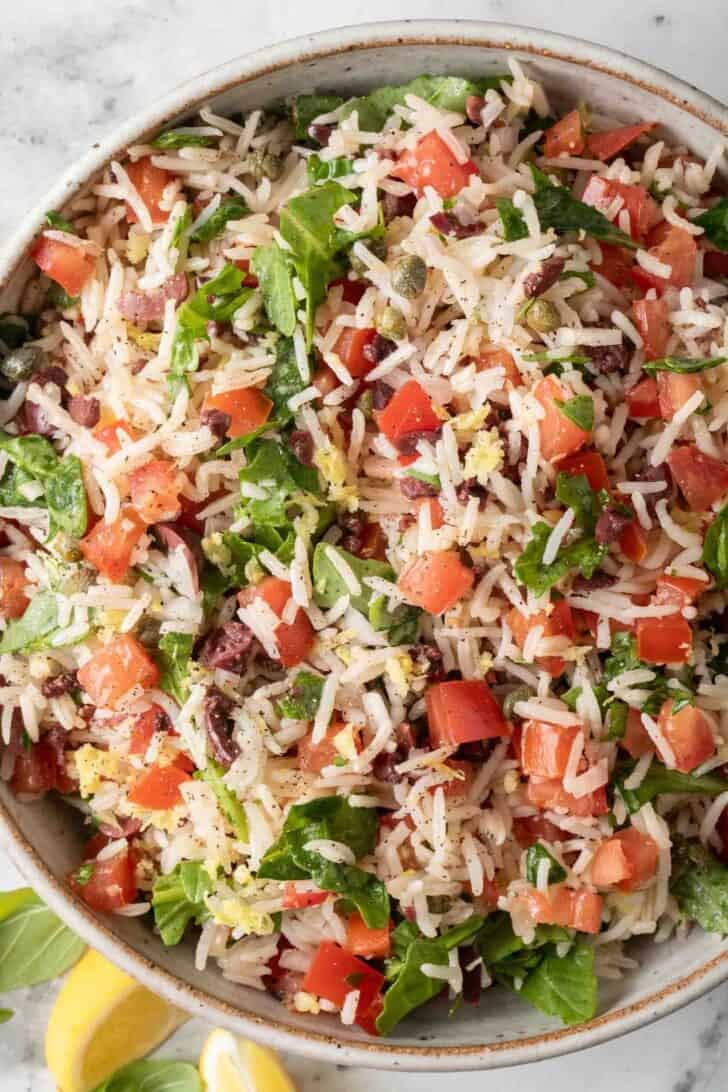 Italian Rice Dish Italian Rice Dish with basmati rice, chopped tomatoes and arugula in a bowl.
