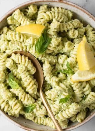 Creamy Pesto Pasta in a bowl with a serving spoon.