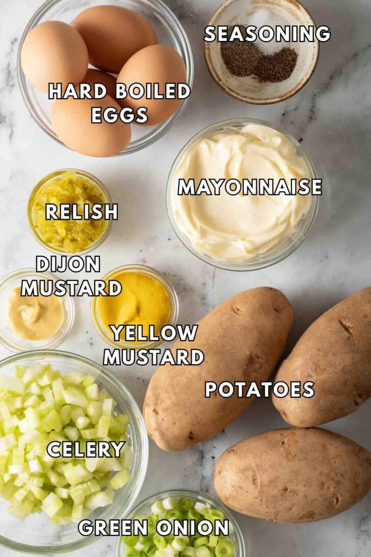 Deviled Egg Potato Salad Recipe Clear glass bowls filled with hard boiled eggs, mayonnaise, celery, dijon mustard and relish.