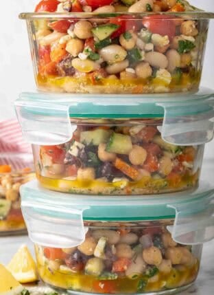 Greek Dense Bean Salad in three glass storage containers.