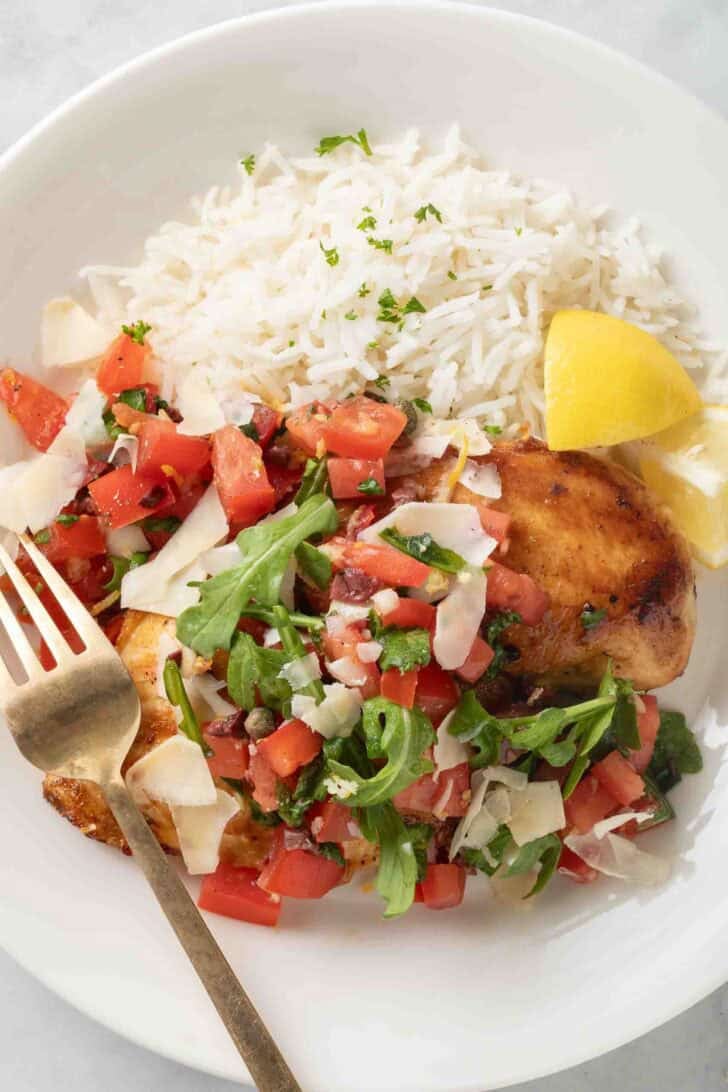 Grilled Bruschetta Chicken Grilled Bruschetta Chicken on a white plate with basmati rice.