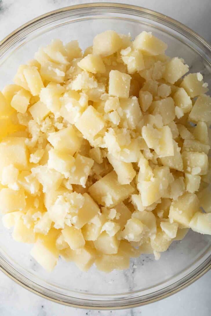How to Make Potato Salad Chopped peeled and cooked potatoes in a bowl.
