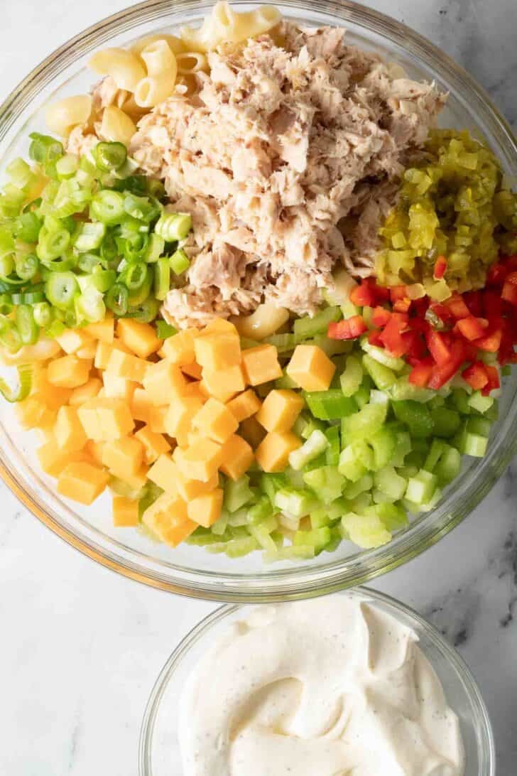 How to Make Tuna Macaroni Salad Tuna Macaroni Salad ingredients in a clear glass bowl.