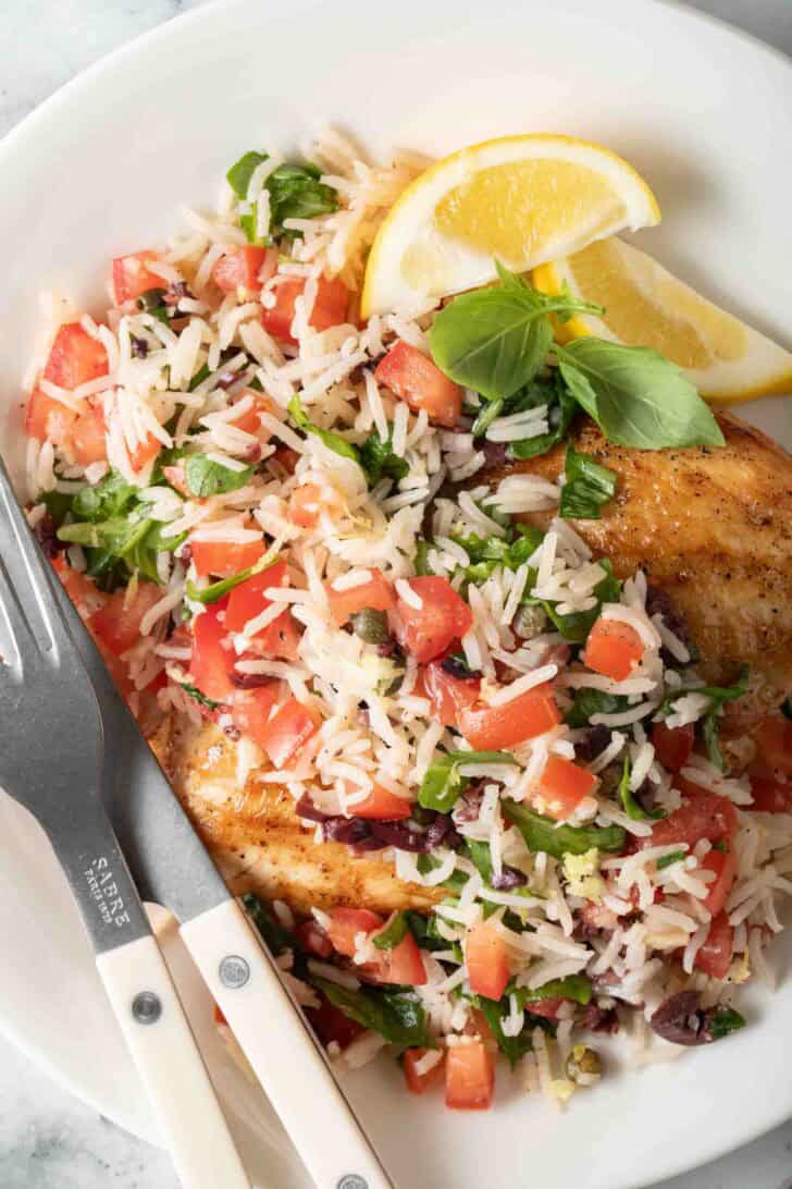 Italian Rice Dish Italian Rice Pilaf on a plate with grilled chicken.