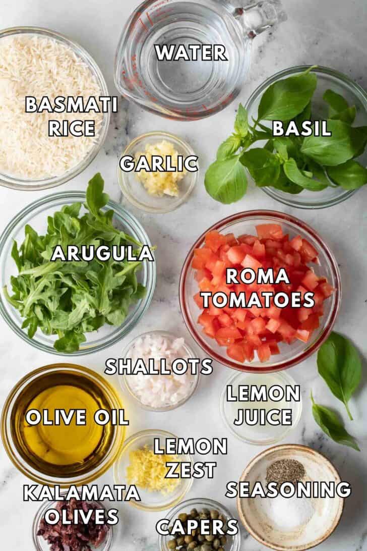 Italian Rice Recipe Clear glass bowls filled with Roma tomatoes, fresh basil, arugula, shallots, lemon zest and basmati rice for Italian Rice recipe.