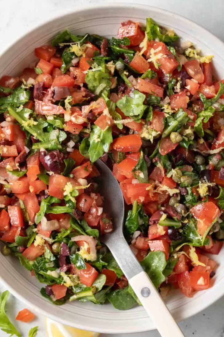 Italian Salsa Italian Salsa in a white bowl with a spoon.