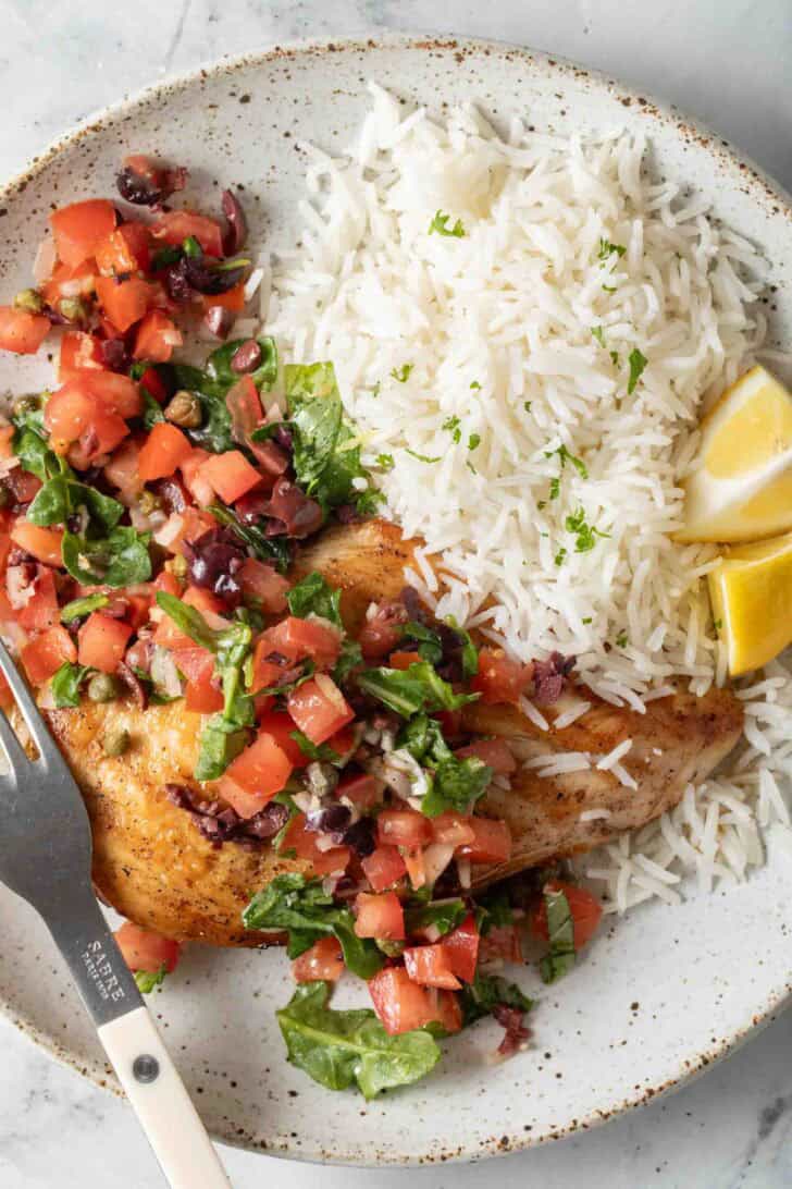 Fresh Italian Tomato Salsa Fresh Italian Tomato Salsa over chicken on a plate.