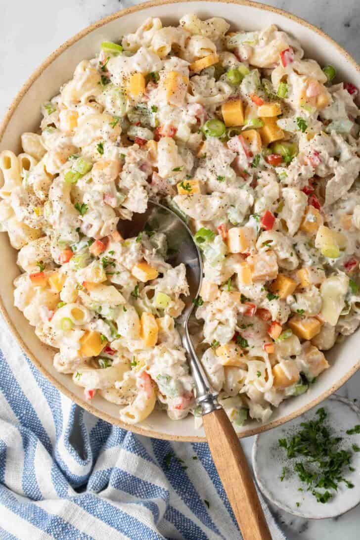Tuna Macaroni Salad Tuna Macaroni Salad in a bowl with a serving spoon.