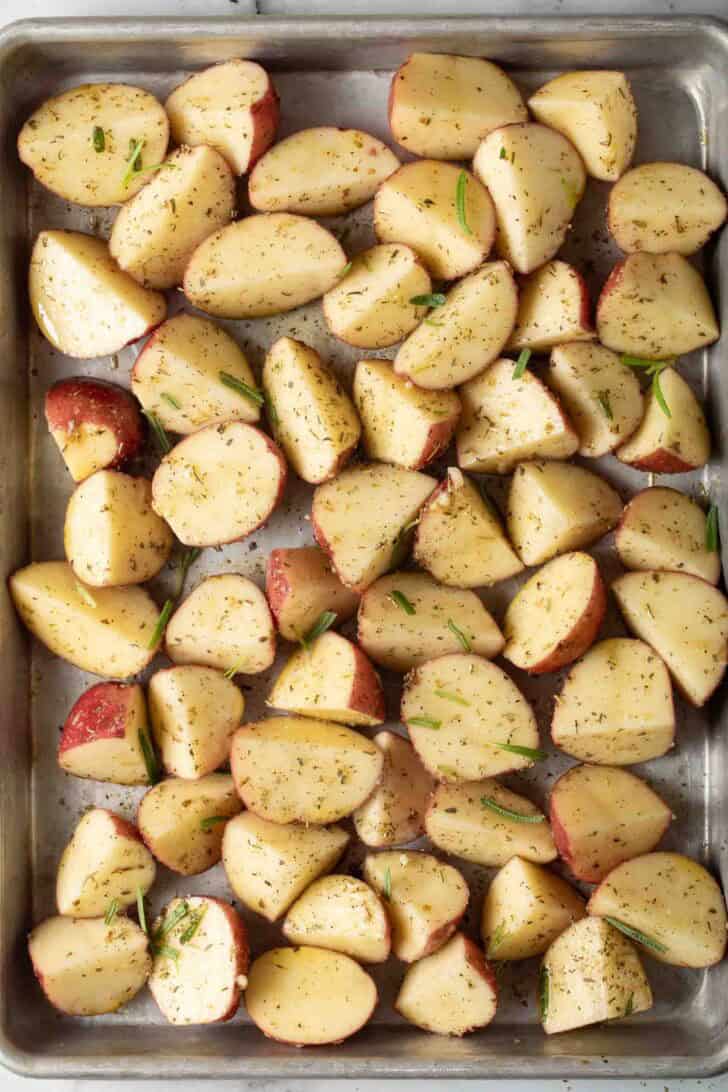 How to Make Oven Roasted Red Potatoes Seasoned Red Potatoes cut in half for oven roasted red potatoes recipe.