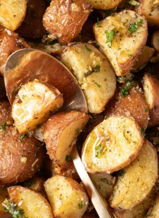 Oven Roasted Red Potatoes with rosemary in a white bowl.