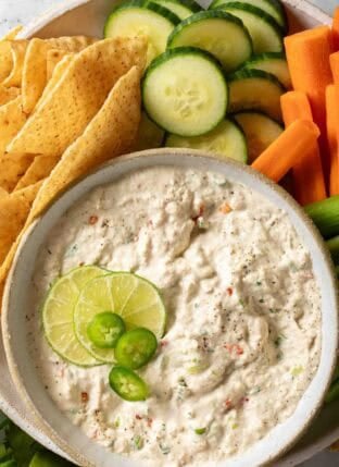 Tuna Dip in a bowl next to sliced cucumber, carrot and celery.