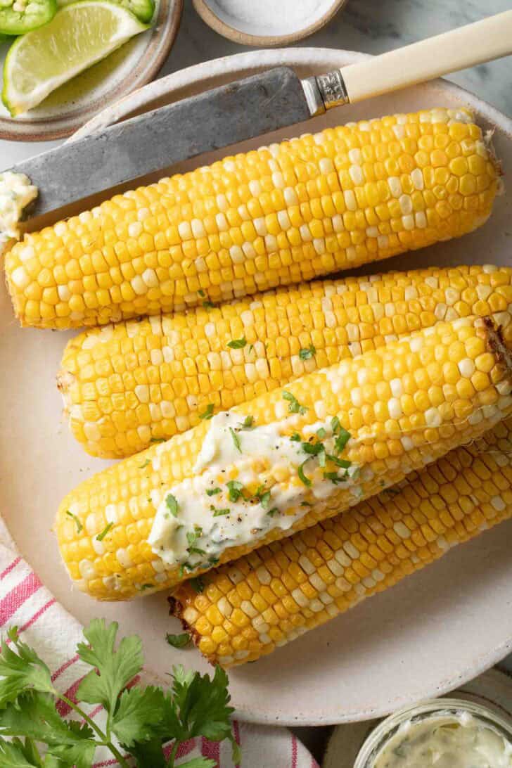 Air Fried Corn on the Cob Air Fried Corn on the cob on a plate slathered with butter.