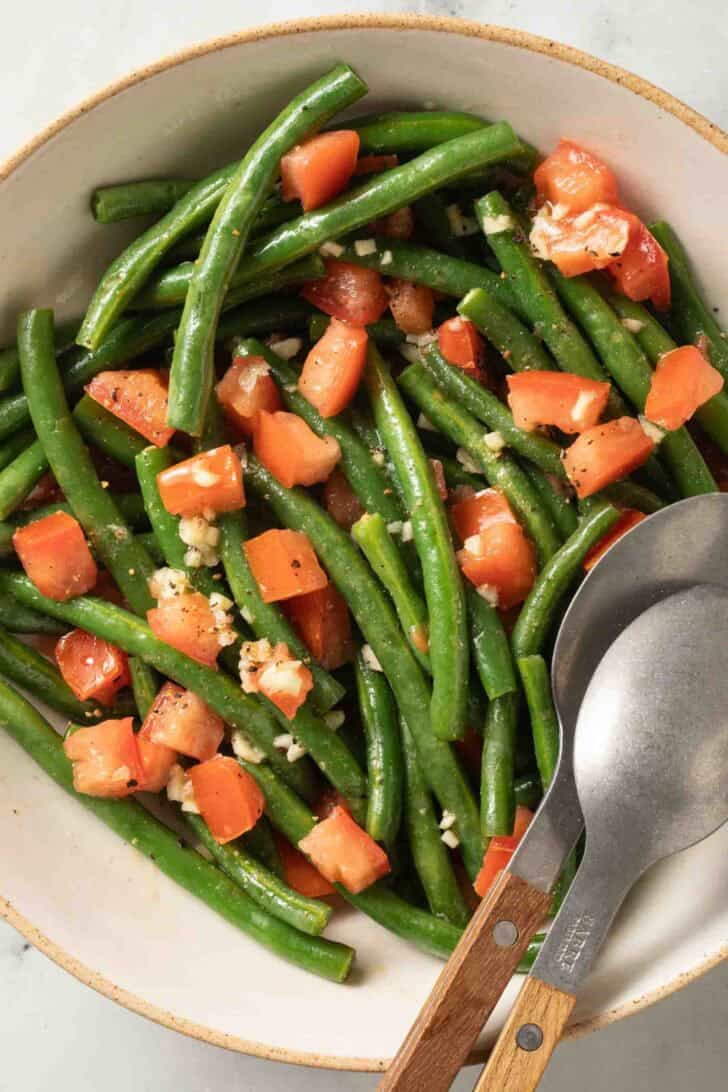 Cold String Bean Salad Cold String Bean Salad in a bowl with serving spoons.