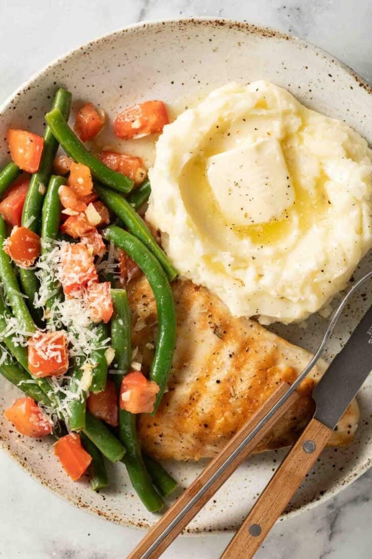 Marinated Green Beans Salad Marinated Green Bean Salad on a plate with mashed potatoes and grilled chicken.