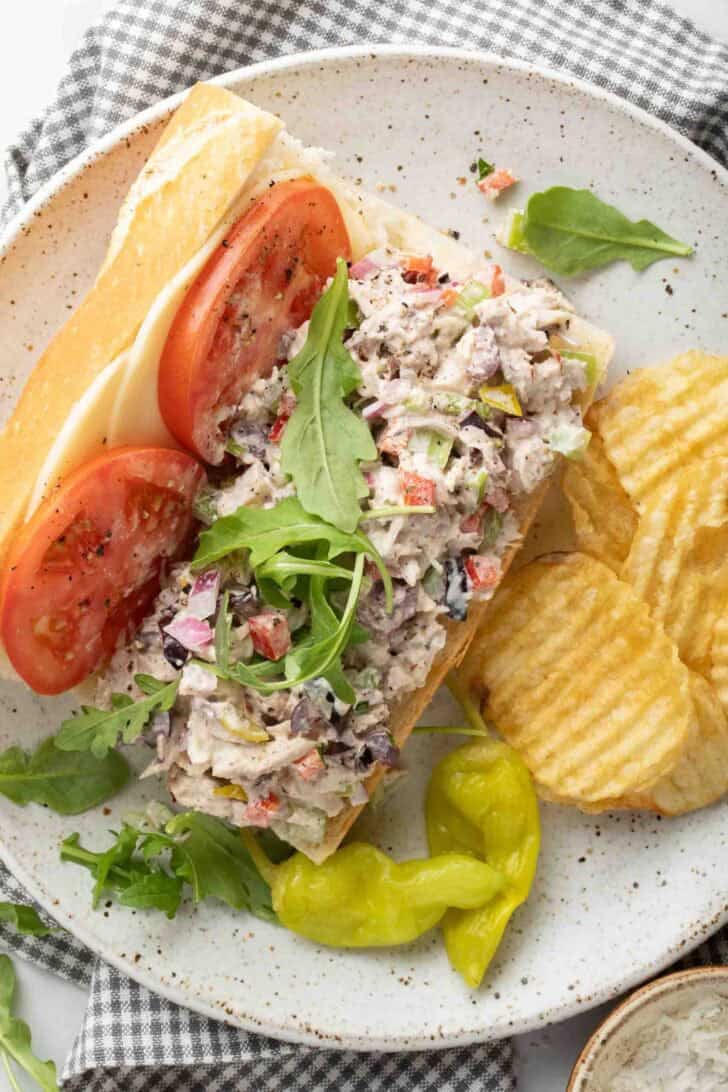 Chicken Italian Salad Italian Chicken Salad on a baguette with cheese and tomatoes.