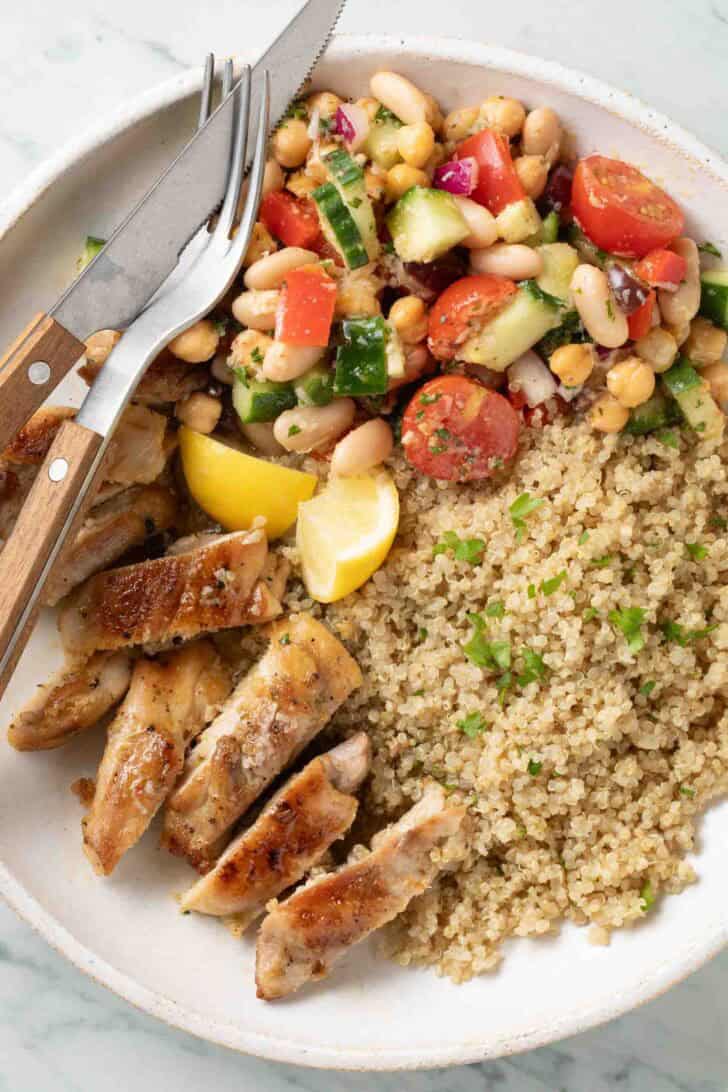 Rice Cooker Quinoa Rice Cooker Quinoa on a plate with cooked chicken.