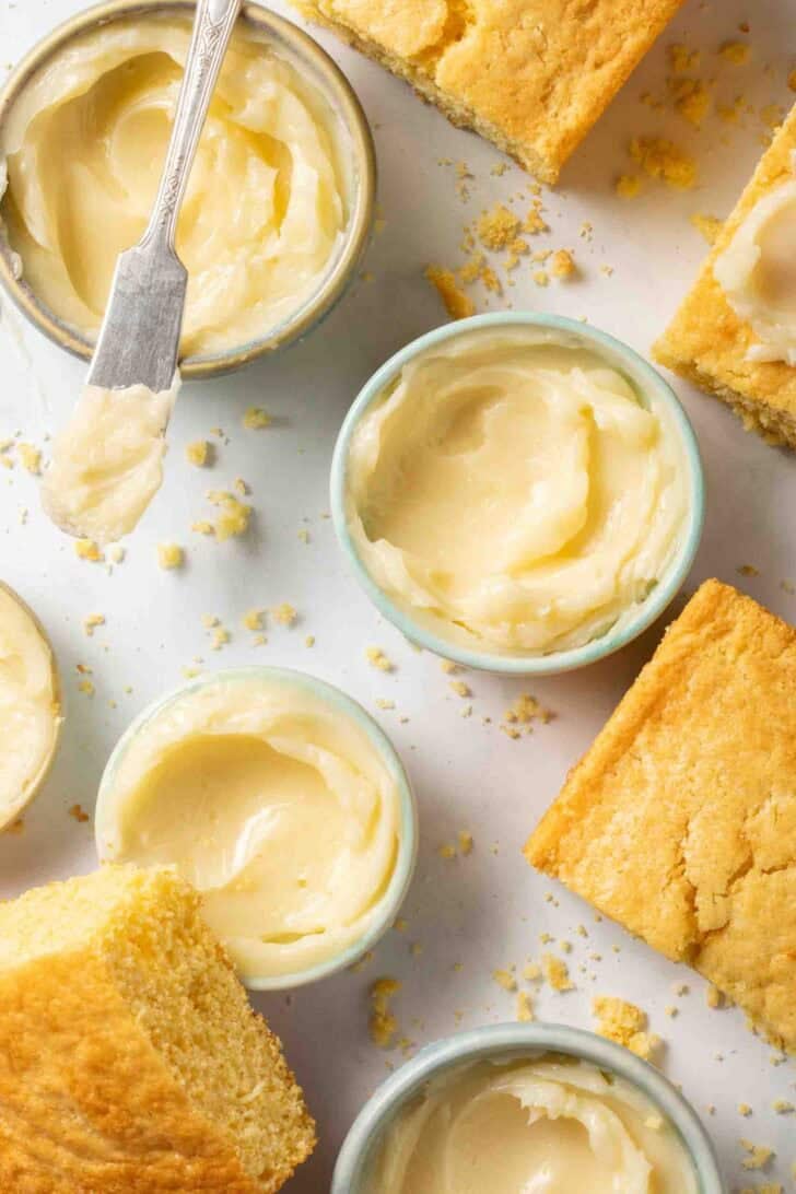 Honey Butter Recipe Honey Butter is small bowls with pieces of cornbread.