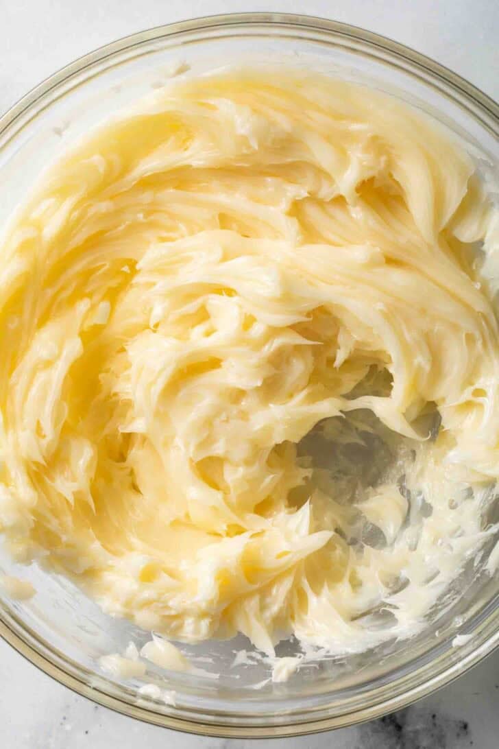 How to Make Honey Butter Whipped Honey Butter in a clear glass mixing bowl.