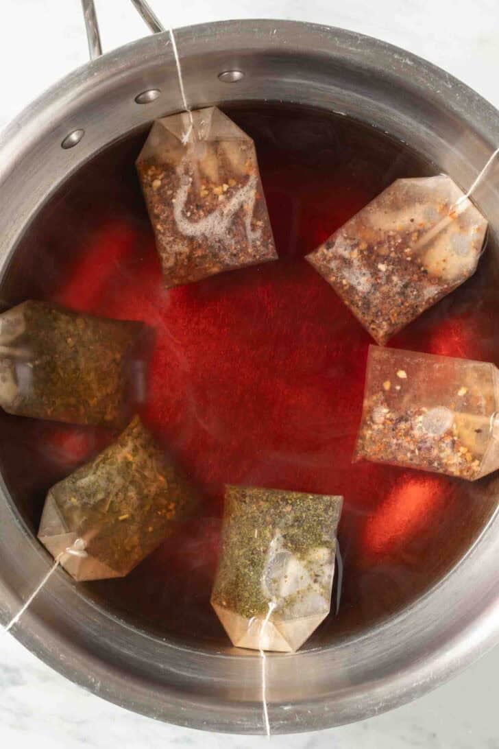 How to Make Iced Tea Tea bags steeping in water in a pot.