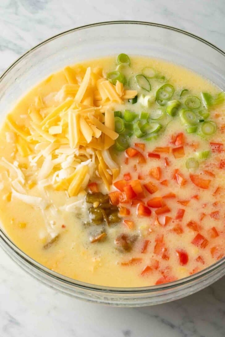 How to Make Mexican Cornbread Ingredients for Mexican Cornbread in a glass mixing bowl.
