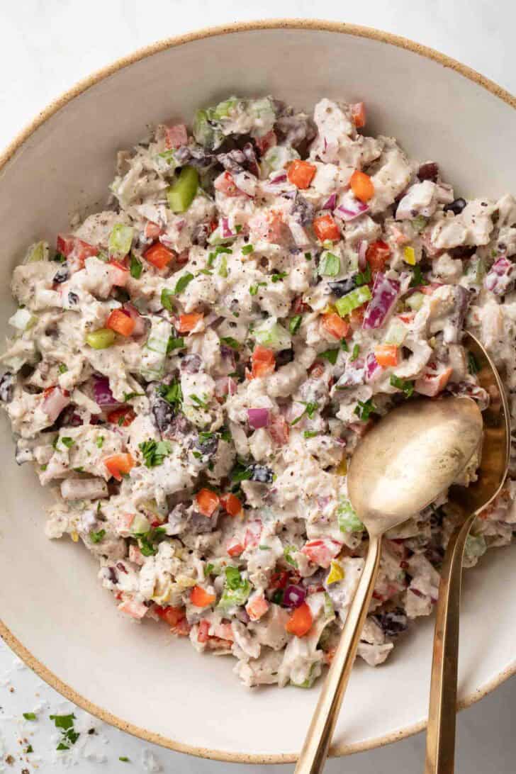 Italian Chicken Salad Italian Chicken Salad in a bowl with two serving spoons.