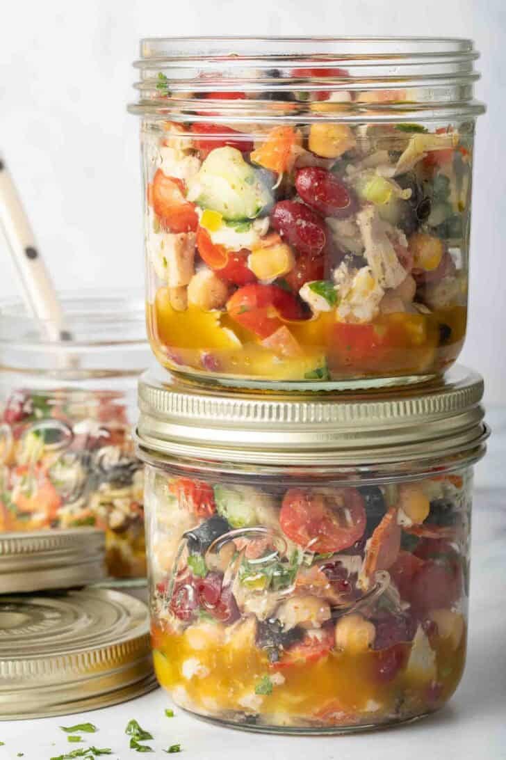 Dense Bean Salad Dense Bean Salad in clear glass mason jars.
