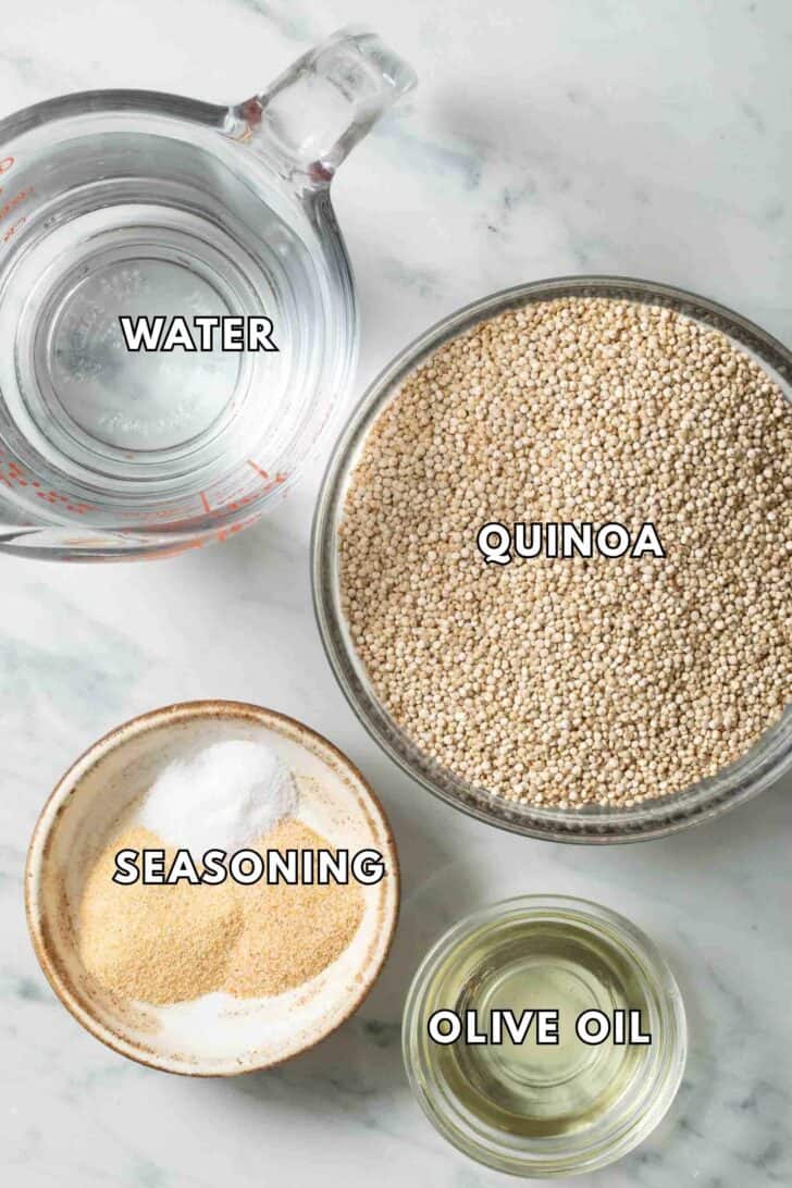 How to Cook Quinoa in a Rice Cooker Clear glass bowls filled with water, quinoa, olive oil and seasoning for how to cook quinoa in a rice cooker recipe.