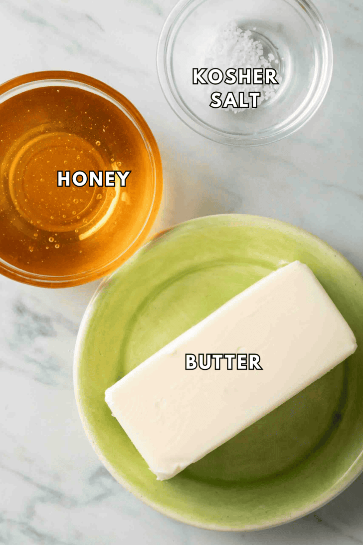 Honey Butter Recipe A stick of butter next to a clear glass bowl of honey for a honey butter recipe.