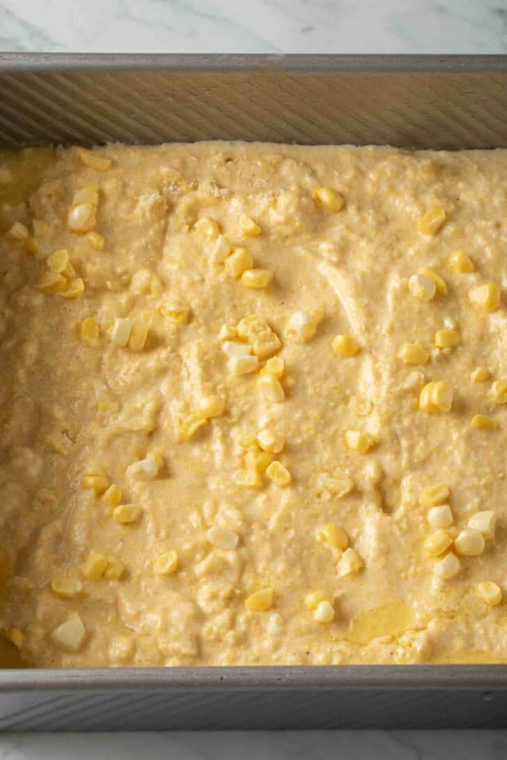 Cornbread From Scratch Cornbread from scratch batter in a baking pan.