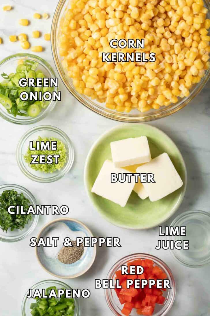 Skillet Corn Recipe Clear glass bowls filled with corn kernels, green onion, butter, red pepper and jalapeno for a Skillet Corn Recipe.