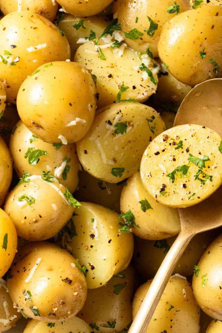 Butter Potatoes Butter Potatoes in a bowl with a gold serving spoon.