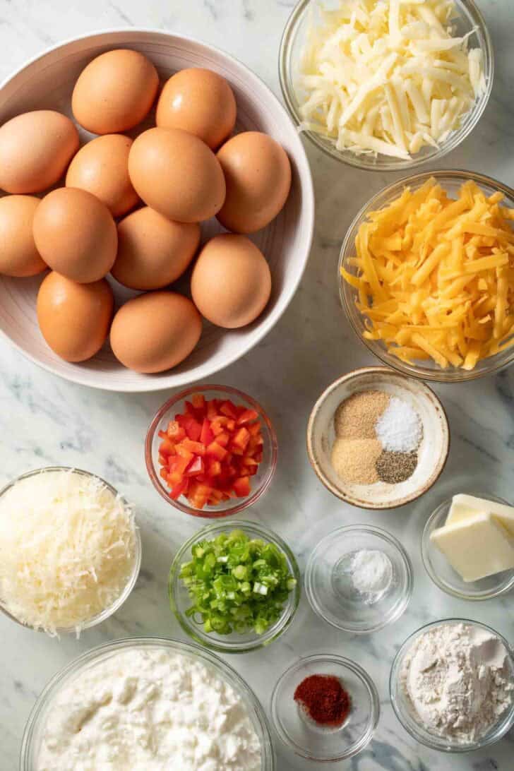 Cottage Cheese Egg Bake Recipe Ingredients for Cottage Cheese Egg Bake recipe. Bowls of eggs, grated cheese, butter and green onion.