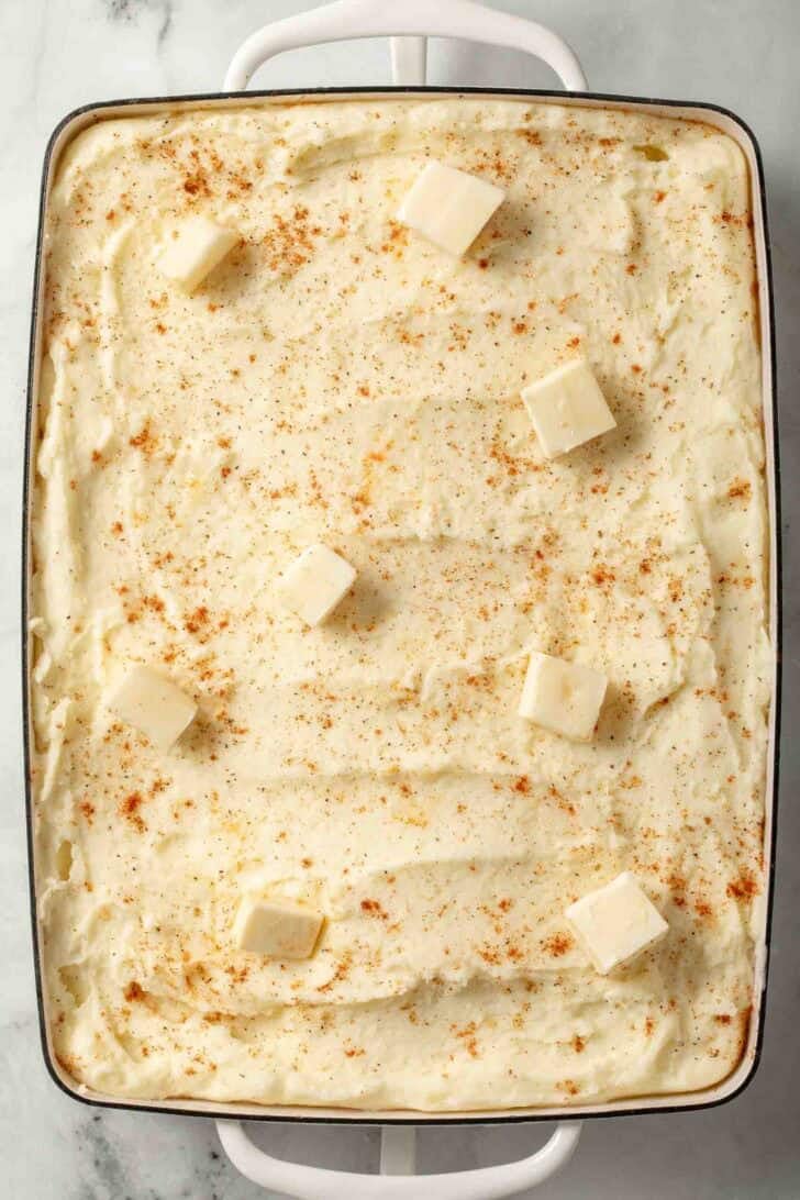 Mashed Potatoes with Cream Cheese Make Ahead Mashed Potatoes with cream cheese in a white skillet.