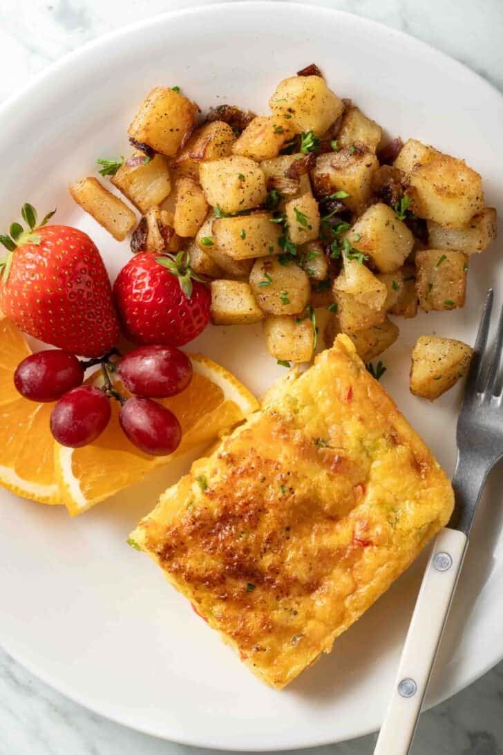Egg Bake with Cottage Cheese A slice of Egg Bake with Cottage Cheese on a white plate.