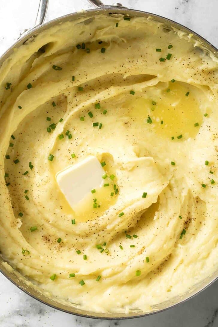 Mashed Yukon Gold Potatoes Mashed Yukon Gold Potatoes in a pot with melted butter,