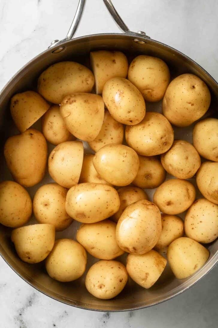 How to Make Parsley Potatoes Baby Yukon gold potatoes in a stainless steel pot for a recipe for Parsley Potatoes.