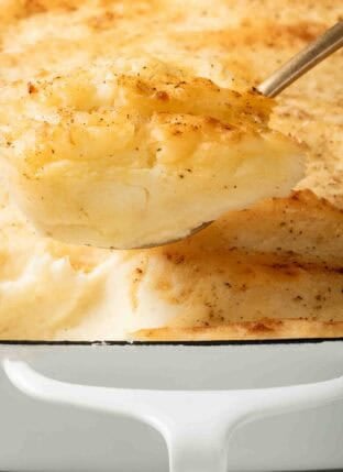 Make Ahead Mashed Potatoes with cream cheese in a white baking dish.