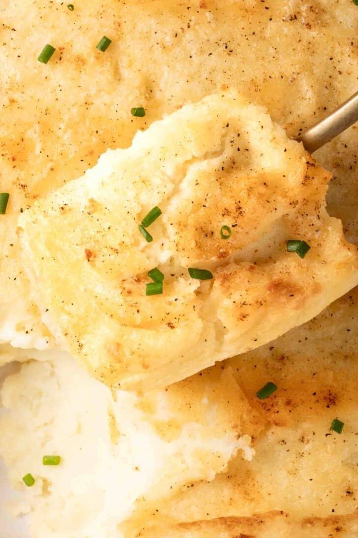 Make Ahead Mashed Potatoes Make Ahead Mashed Potatoes in a white baking dish.