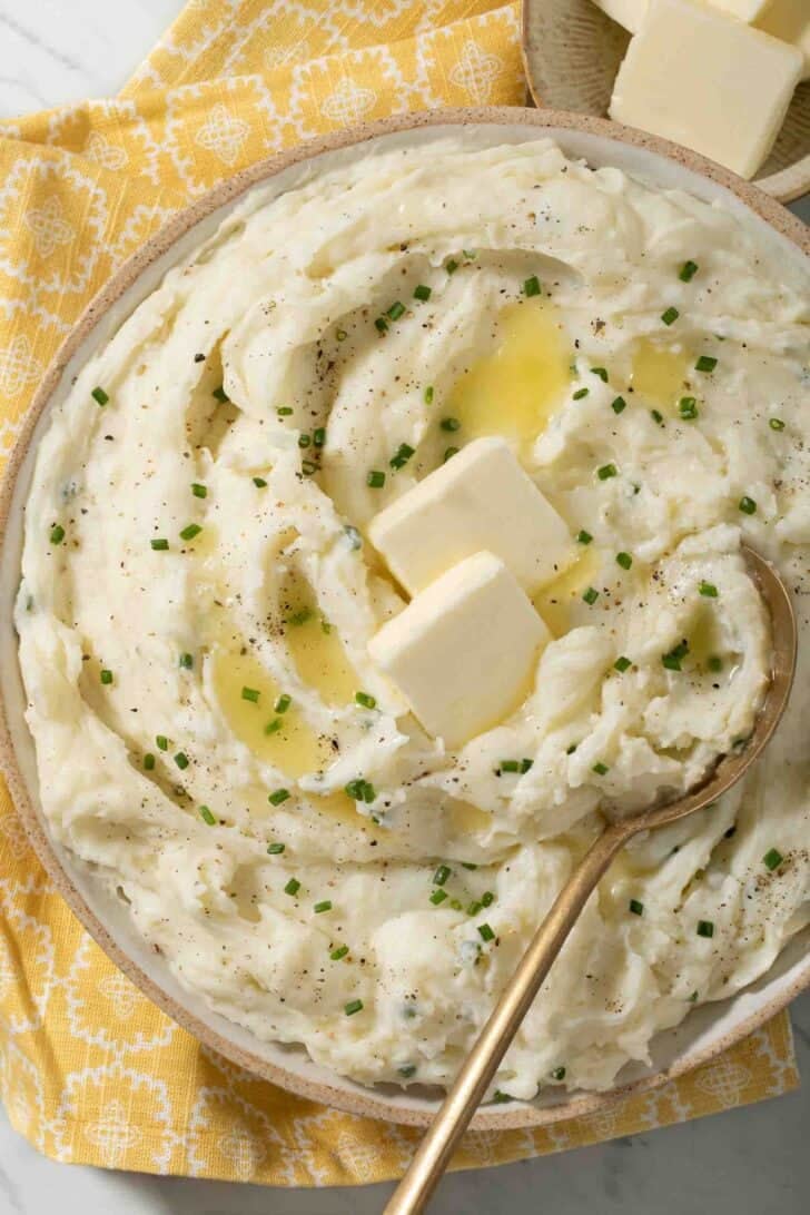 Creamy Sour Cream Mashed Potatoes Creamy Sour Cream Mashed Potatoes in a bowl with a gold serving spoon.