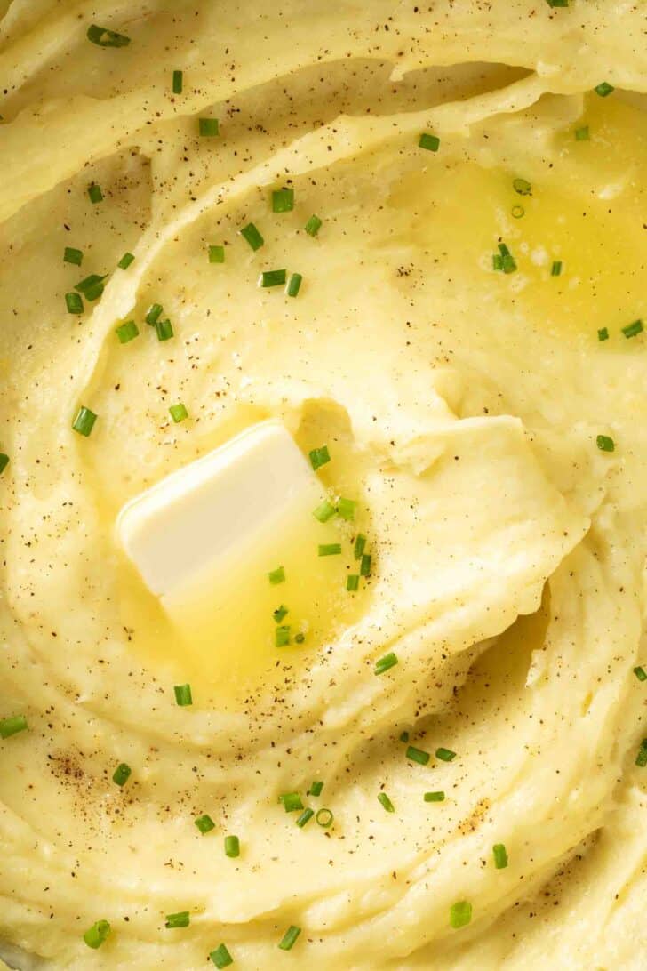 Mashed Yukon gold Potatoes Mashed Yukon Gold Potatoes in a pot with melted butter.