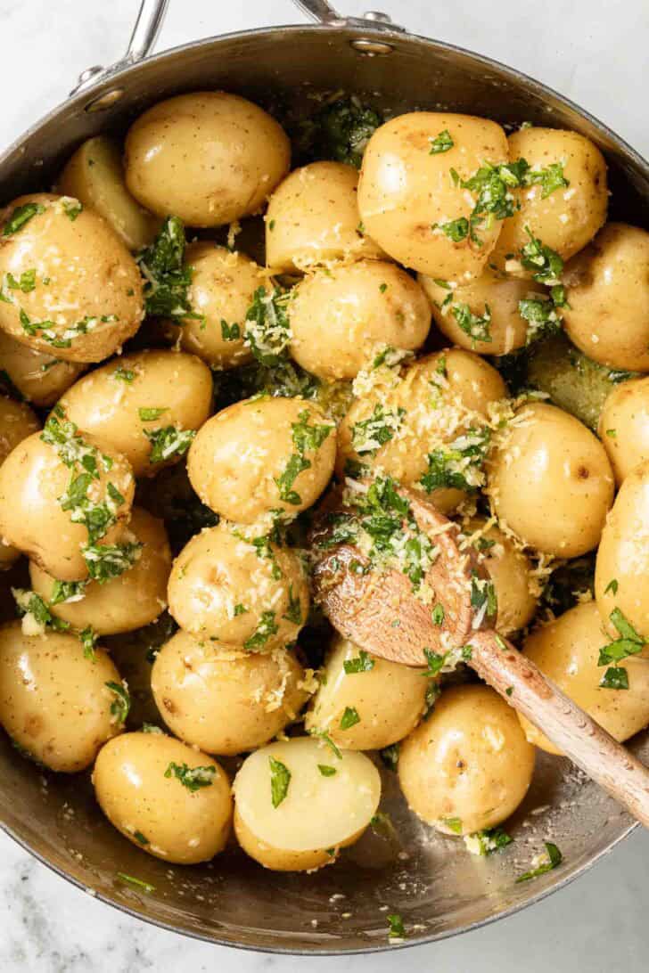 Parsley Potatoes Recipe Parsley Potatoes in a stainless steel pot with a wooden spoon.