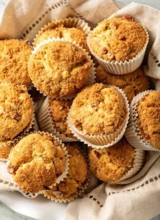 Pumpkin Cream Cheese Muffins in a cloth napkin lined bowl.