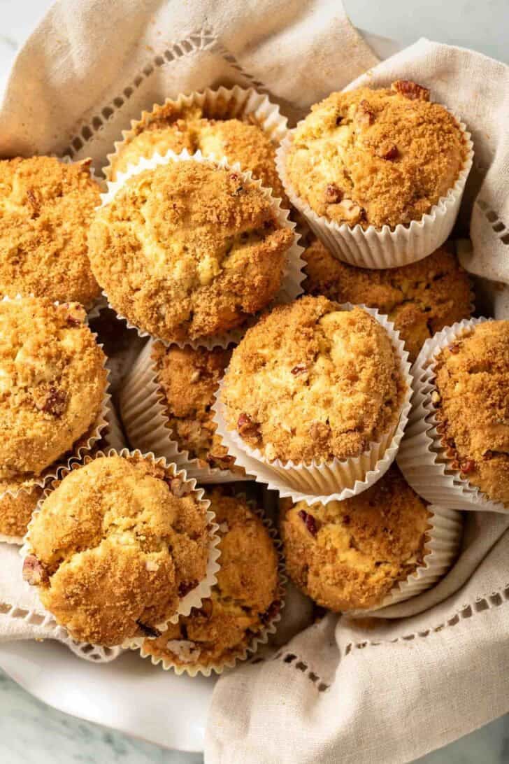 Pumpkin Cream Cheese Muffins Pumpkin Cream Cheese Muffins in a bowl lined with a cloth napkin.