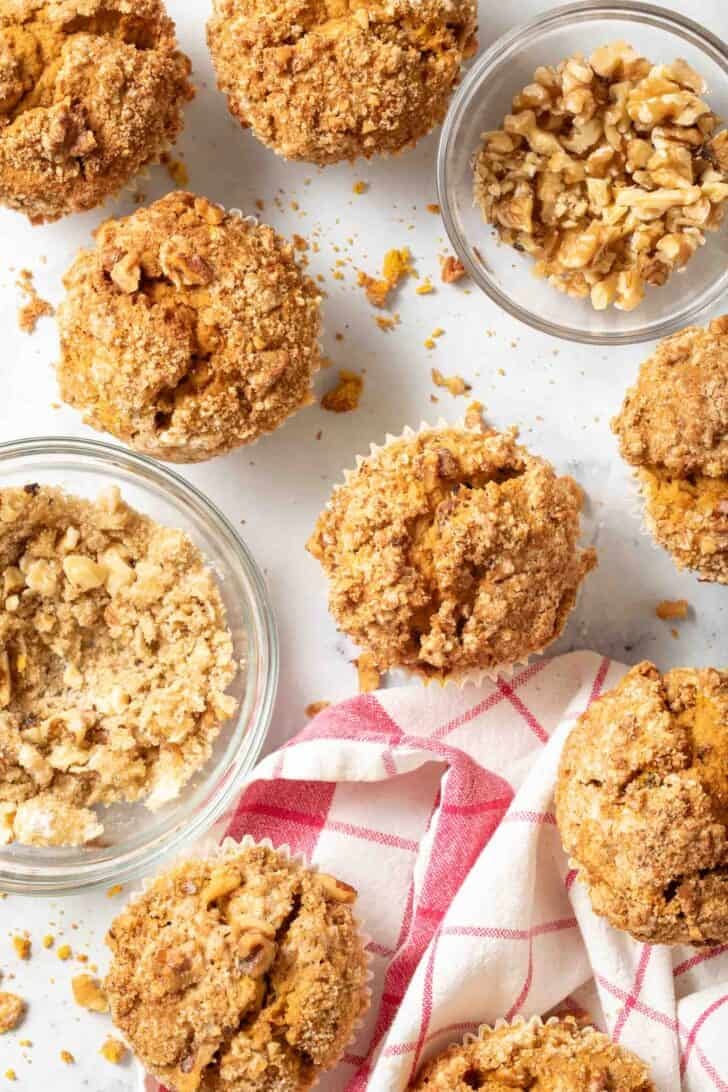 Pumpkin Muffins Recipe Pumpkin Muffins next to a clear glass bowl of streusel.
