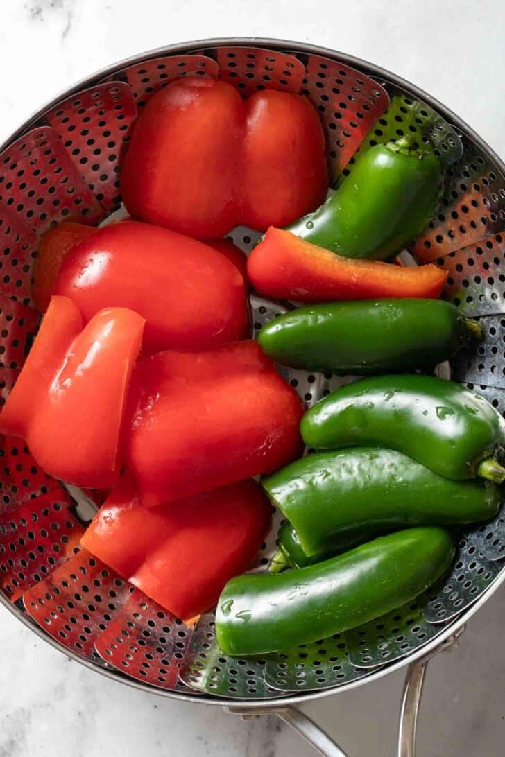 Jalapeno Cornbread Recipe Steamed red bell pepper and jalapeno in a steamer basket for Jalapeno Cornbread Recipe.