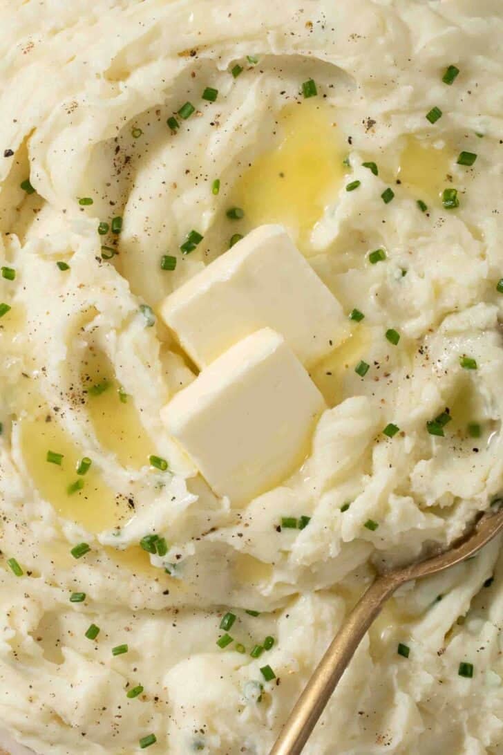 Sour Cream Mashed Potatoes Recipe Sour Cream Mashed Potatoes topped with butter and snipped chives.