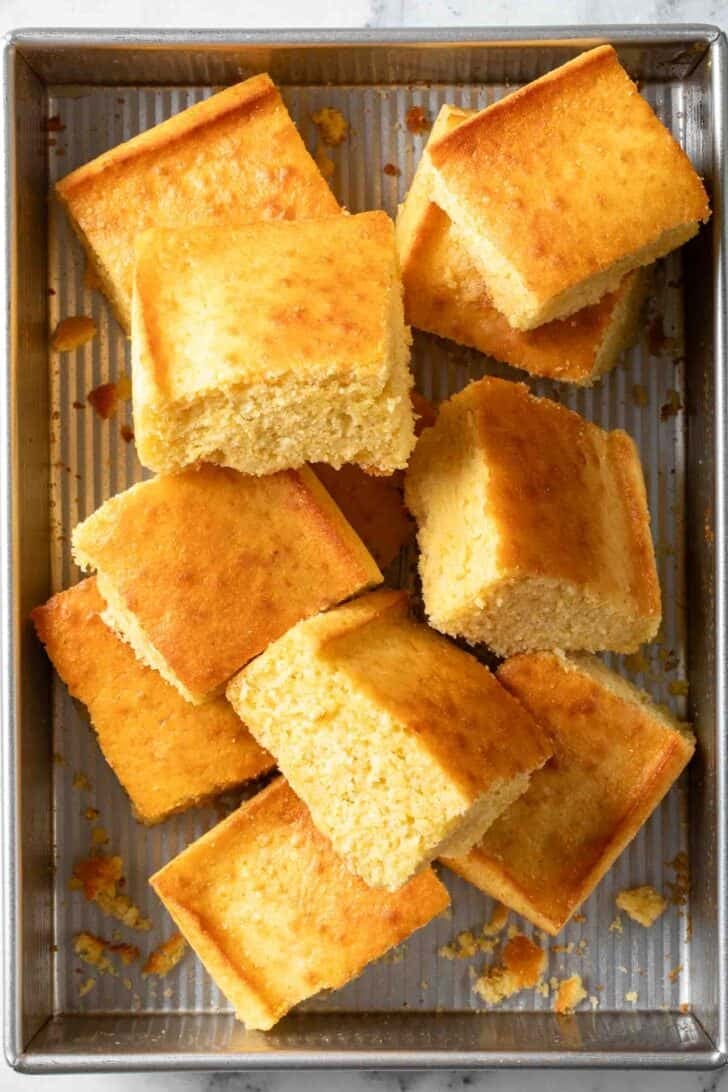How to Make Sweet Cornbread Cut pieces of Sweet Cornbread stacked in a baking pan.