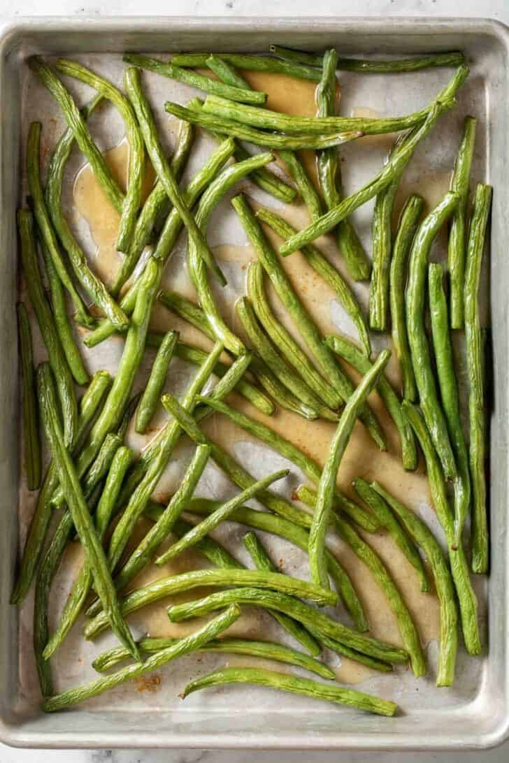 How to Roast Green Beans Roasted Green Beans on a baking sheet.