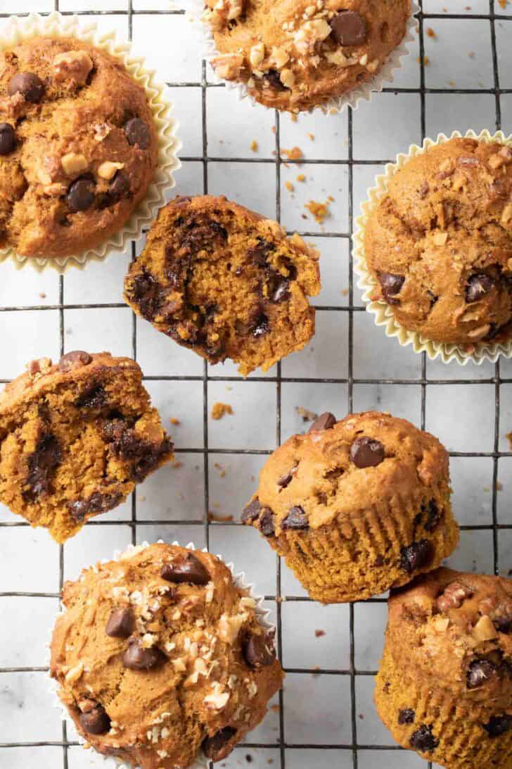 Pumpkin Chocolate Chip Muffins Recipe Baked Pumpkin Chocolate Chip Muffins on a cooling rack.