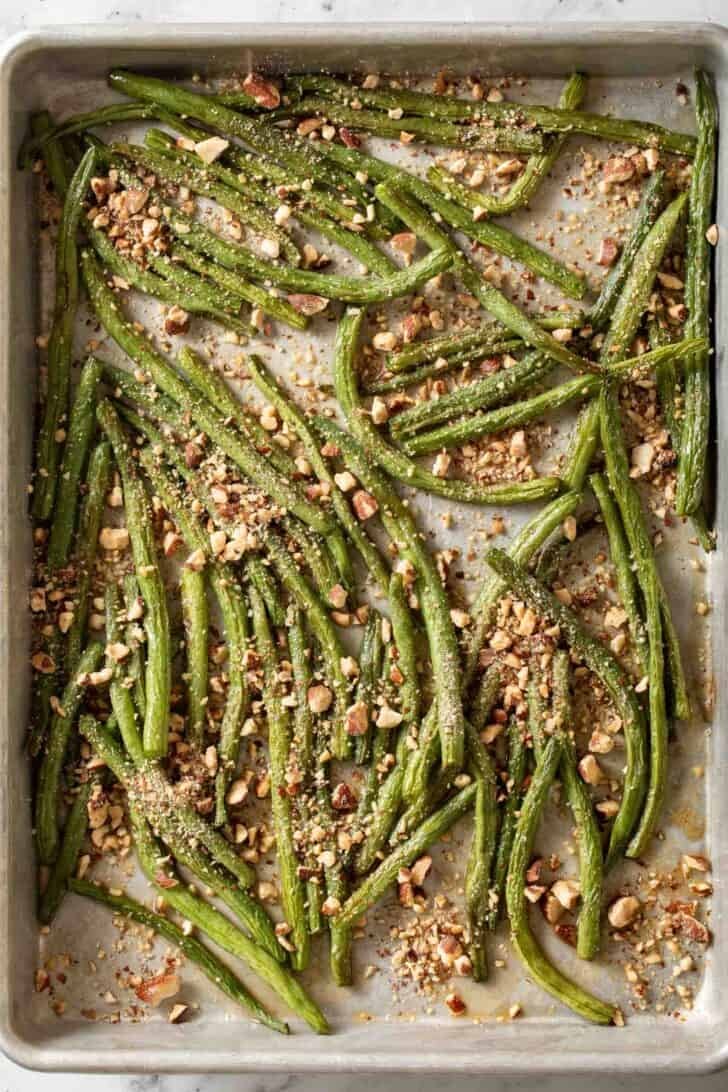 Roasted String Beans Recipe Roasted String Beans with almonds on a baking sheet.